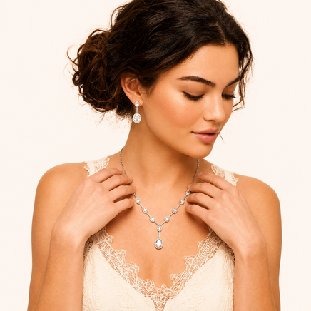 Model styling white gold plated zirconia necklace with matching oval drop earrings | Olaty