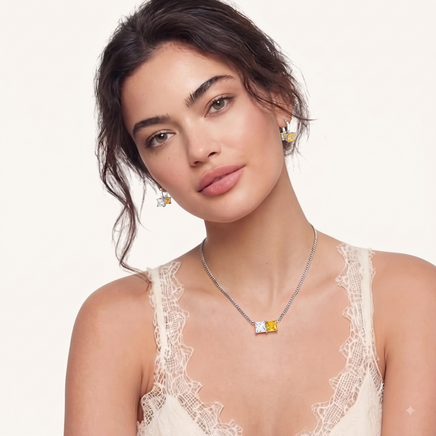 Model wearing matching clear and golden yellow zirconia necklace and drop hoop earrings | Olaty