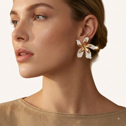 Close-up model wearing white enamel floral statement earring with sculptural gold-tone center | Olaty