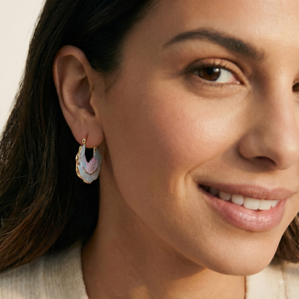 Close-up of model wearing iridescent blue and pink shell hoop earring with gold-tone detailing | Olaty