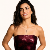 Model wearing linear baguette zirconia necklace and matching huggie earrings | Olaty