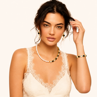 Model wearing pearl necklace with black and clear zirconia stones and matching drop earrings | Olaty