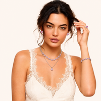 Model wearing layered pink heart zirconia necklaces with matching earrings, bracelet and ring | Olaty