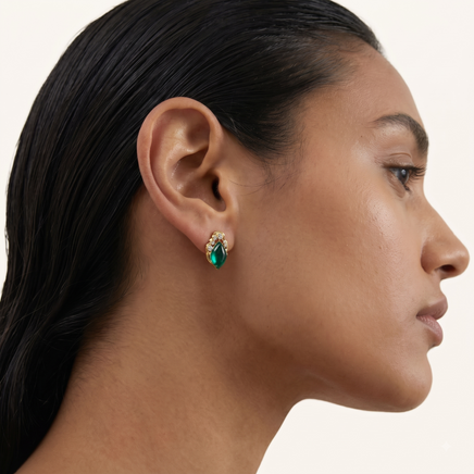 Profile close-up of model wearing emerald Liuli glass stud earring with gold-tone and Zirconia detailing | Olaty