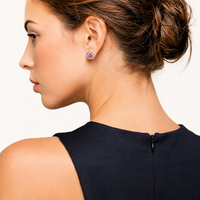 Pink moissanite halo stud earring worn in profile with polished sterling silver setting | Olaty