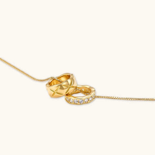 Product video showcasing Celestial Twin Ring Pendant Necklace with intertwined circular pendants and elegant celestial-inspired details | Olaty