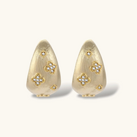 Product video showcasing Clover Statement Hoop Earrings with clover-inspired details and a bold sculptural hoop design | Olaty