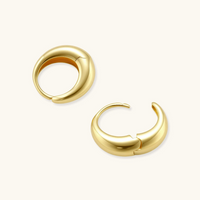 Product video showcasing Golden Era Huggie Hoops with a polished gold-tone finish and elegant sculptural huggie hoop design | Olaty