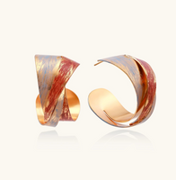Product video showcasing Twisted Flame Statement Hoop Earrings with sculptural flame-inspired curves and a polished gold-tone finish | Olaty