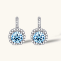 Product video showcasing GRA Certified Blue Moissanite Diamond Celestial Halo Drop Earrings with brilliant blue moissanite stones, sparkling halo details and elegant celestial-inspired drops | Olaty